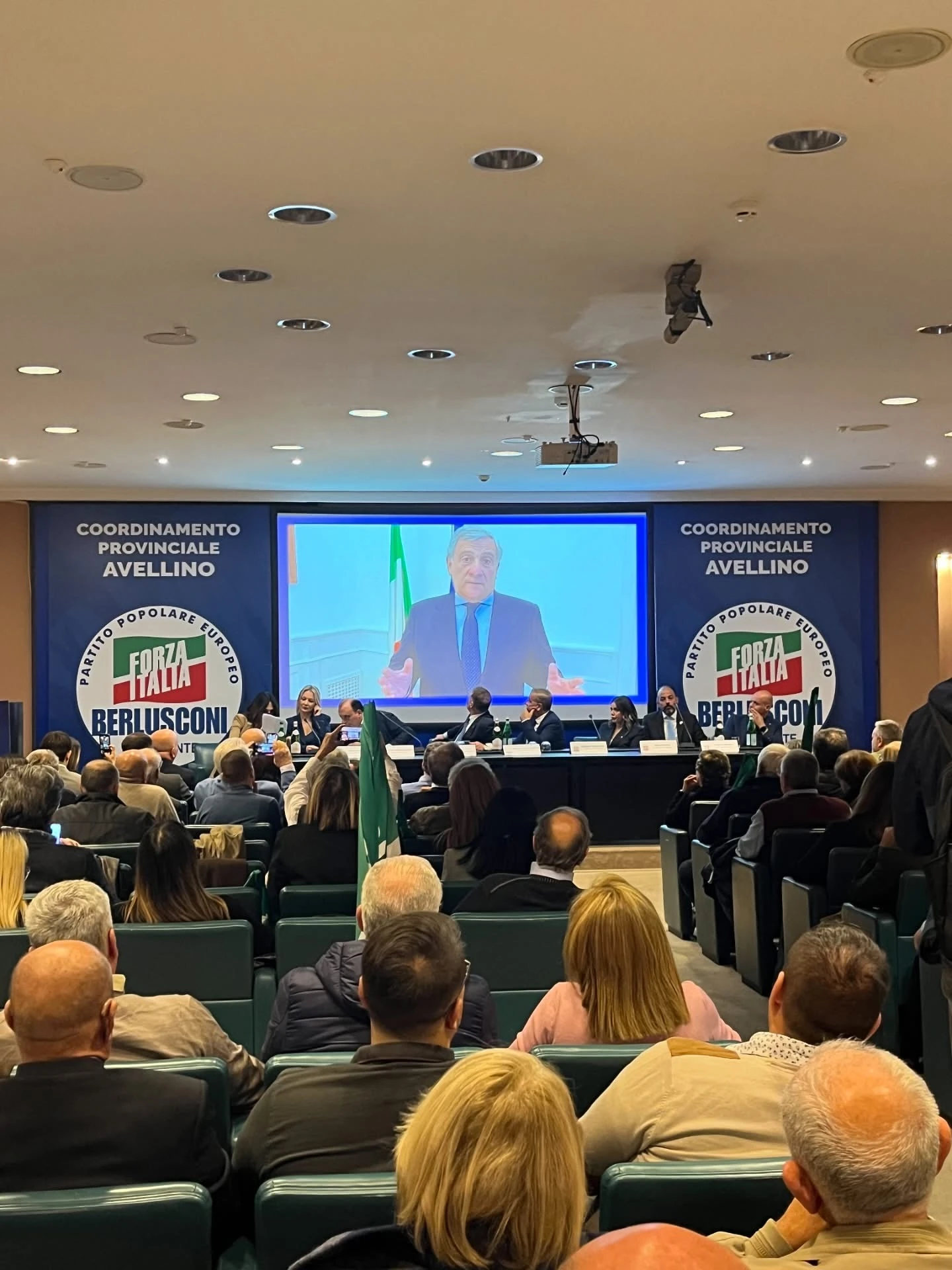 Veduta del pubblico e del palco con un intervento proiettato sullo schermo. Archivio fotografico Regionali 2025.